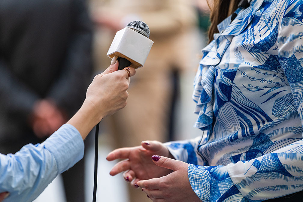 interview with woman in blue patterned shirt
